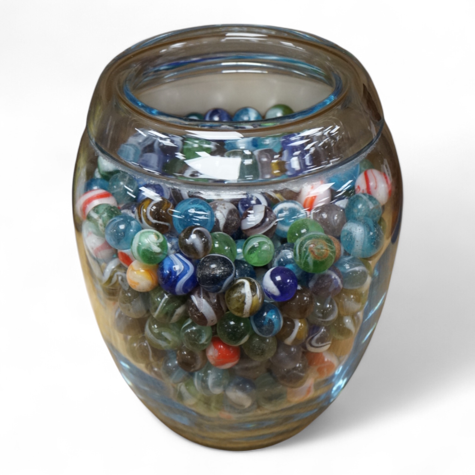 A glass vase possibly by Holmgaard, containing a large collection of late 19th/early 20th century glass marbles, 19cm high